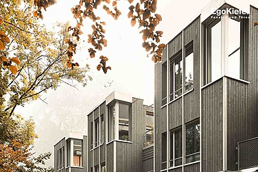 Foto esterna delle quattro moderne case a schiera con grandi finestre in legno/alluminio EgoKiefer "EgoAllstar" e una suggestiva finestra ad angolo