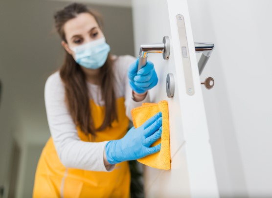 Femme nettoyant une porte